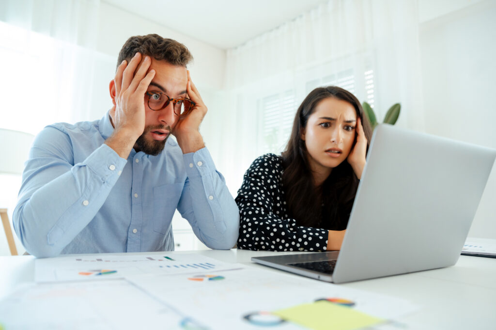 Two brand awareness professionals looking at a website