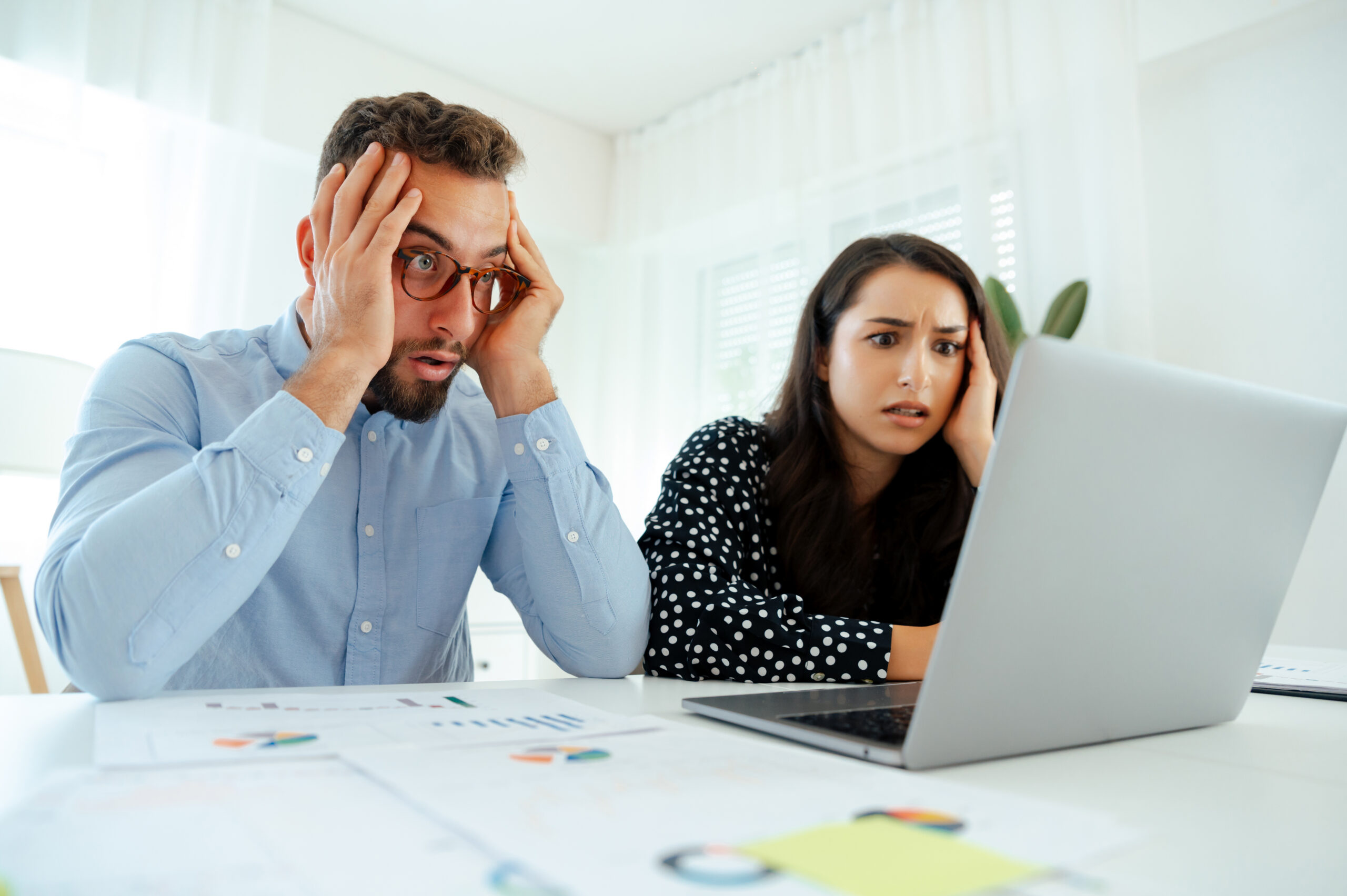 Two brand awareness professionals looking at a website